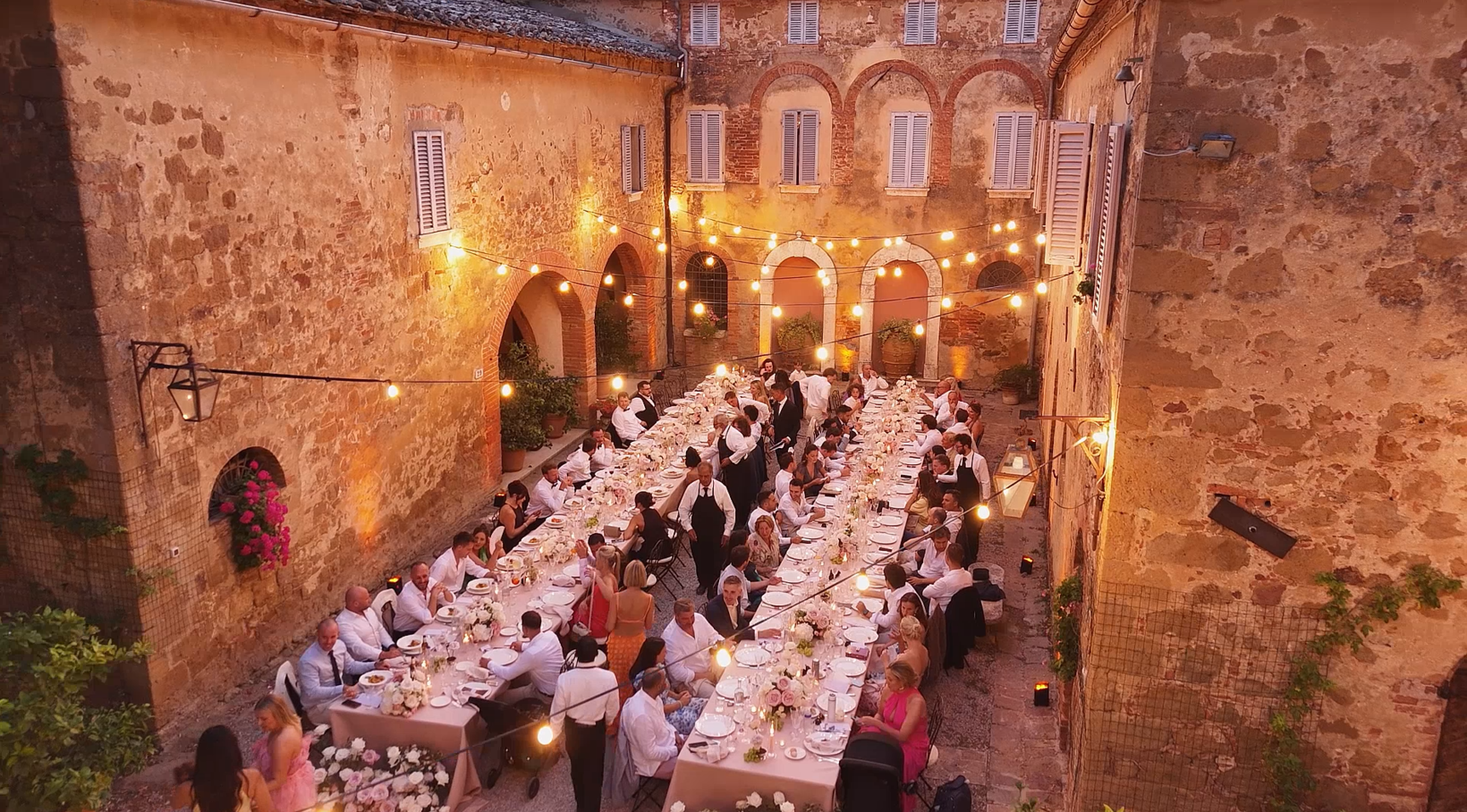 Dimitris Pavlidis Films Italian wedding videographer wedding dinner in the courtyard at borgo sant'ambrogio Tuscany