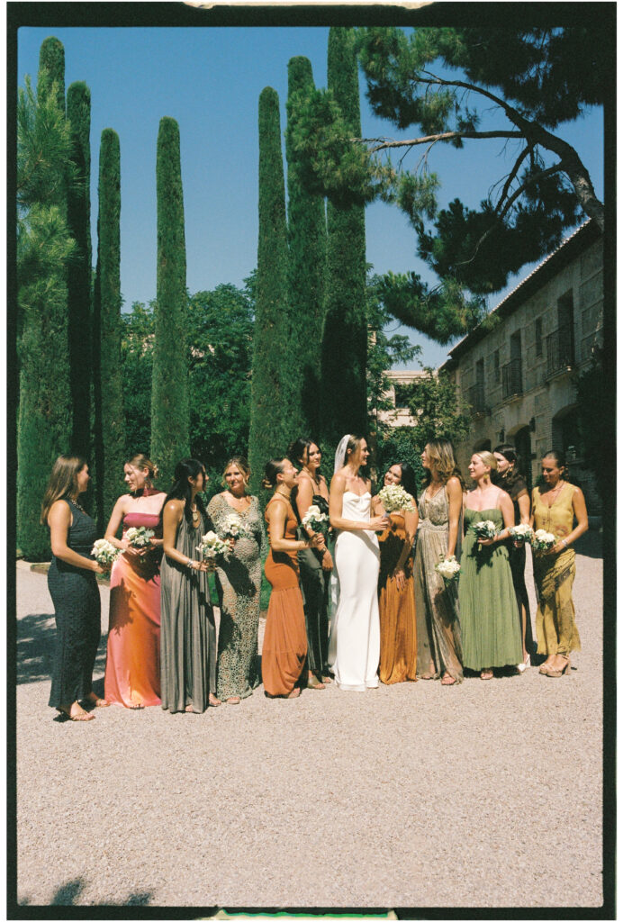 Barbara Markiewicz, Italian wedding photographer film photograph of bride and bridesmaids in lime and copper colours, cypress trees
