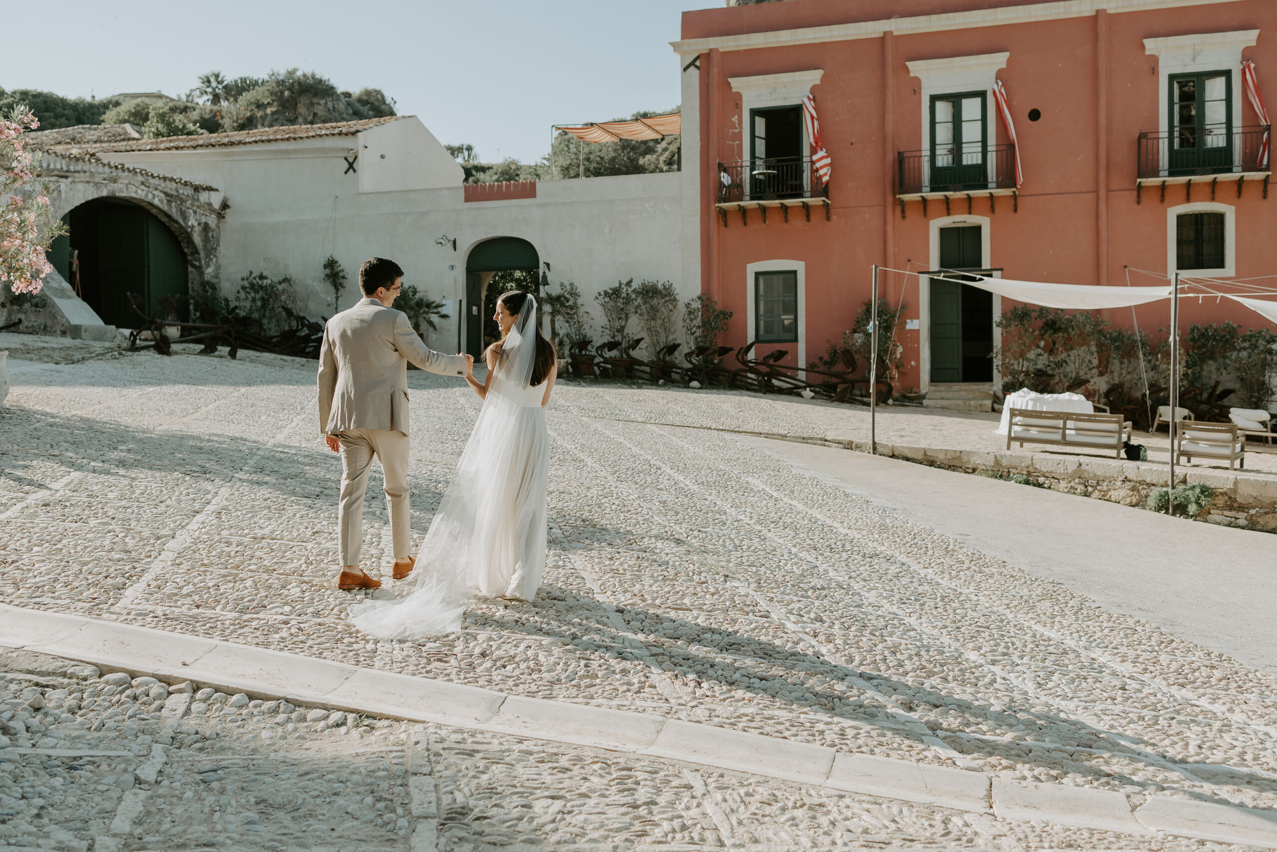 Ester Porto, Sicily wedding planner couple walking at Tonnara di Scopello