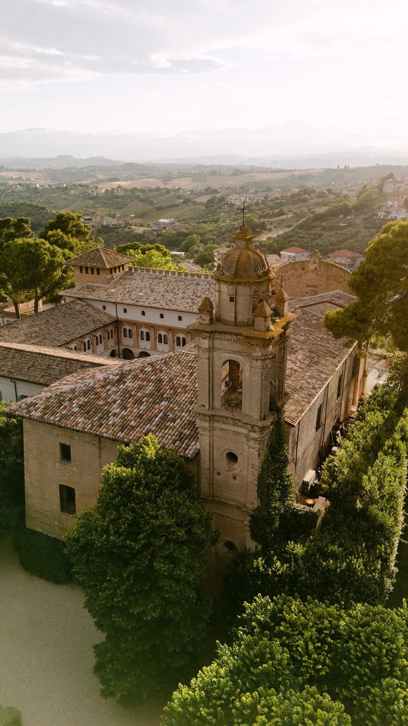 Historic Italian convent wedding venue, courtyard, and bell tower, Abruzzo countryside hills