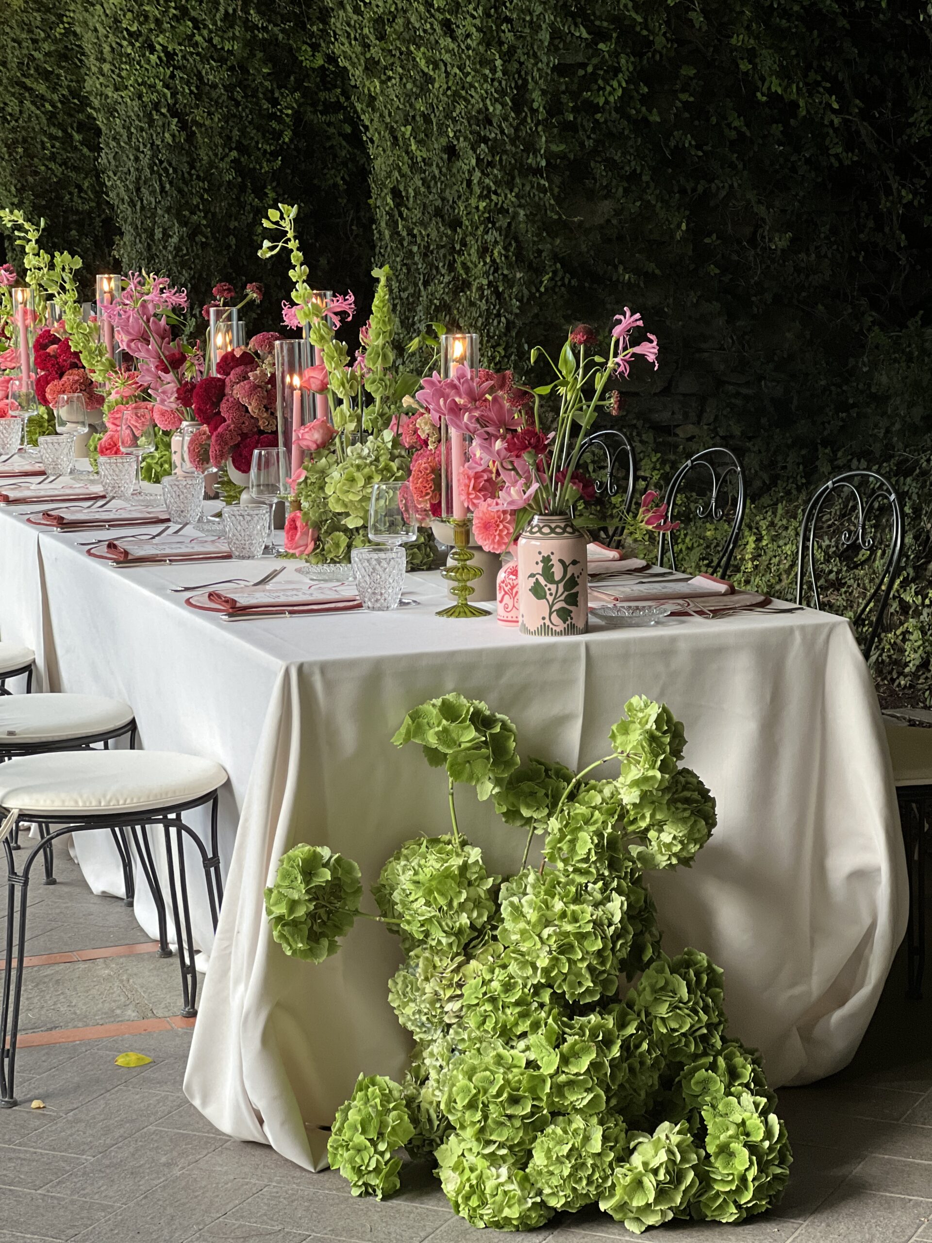 Italian wedding tablescape, pink and green floral arrangements