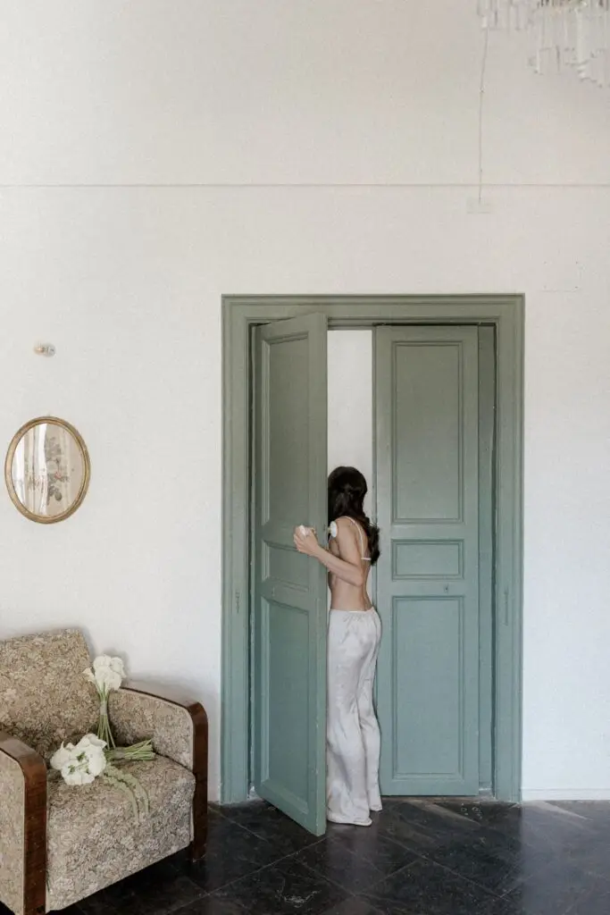Bride getting ready at villa carcara in Sicily, white lily floral bouquet by Alfio Flowers