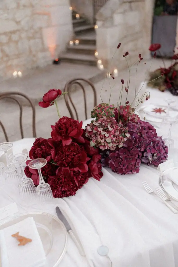 Red and burgundy floral display by Alfio Flowers