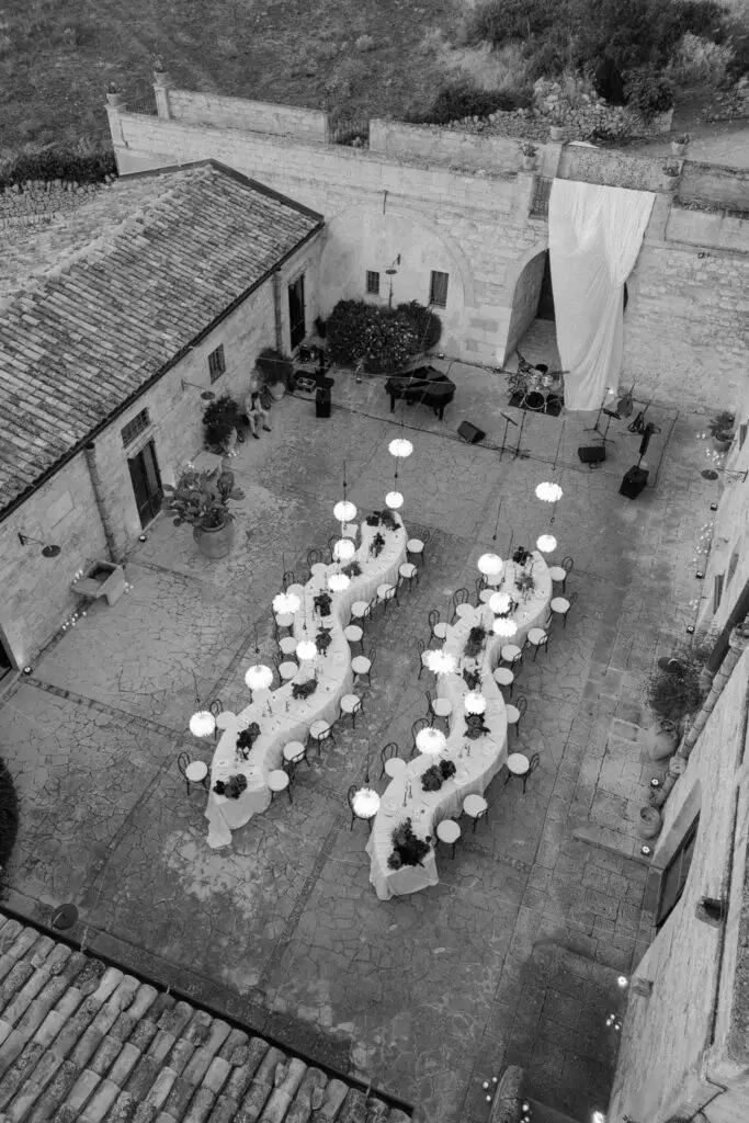 Al fresco dining at Italian wedding in Sicily, long seprentine tables